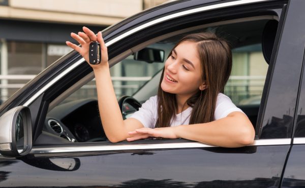 Happy Young Smiling Woman With New Car Key.jpg