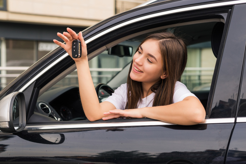 Happy Young Smiling Woman With New Car Key.jpg