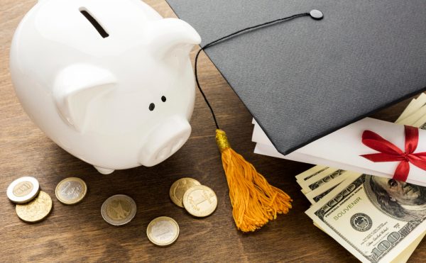 High Angle Piggy Bank With Academic Cap Coins.jpg